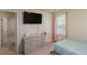 Carpeted bedroom with a twin bed, dresser with TV, and a window at 5622 Laurel Ridge Dr, Atlanta, GA 30344