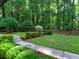 Well manicured backyard featuring lush landscaping, green grass and mature trees at 2540 Rocky Springs Dr, Marietta, GA 30062