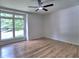 Inviting bedroom with hardwood floors, a modern ceiling fan, and a large window that brings in natural light at 2540 Rocky Springs Dr, Marietta, GA 30062