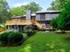 A spacious two-story home with a large wooden deck, lush green lawn, and mature landscaping at 2540 Rocky Springs Dr, Marietta, GA 30062