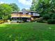 Back of house featuring a large manicured lawn and a multilevel deck at 2540 Rocky Springs Dr, Marietta, GA 30062