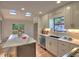 Open kitchen featuring a skylight, stainless appliances, a marble countertop island, and white cabinetry at 2540 Rocky Springs Dr, Marietta, GA 30062