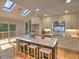 Bright kitchen featuring a skylight, stainless appliances, a marble countertop island, and white cabinetry at 2540 Rocky Springs Dr, Marietta, GA 30062