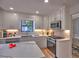 Renovated kitchen features stainless steel appliances, marble countertops, and white cabinets with gold hardware at 2540 Rocky Springs Dr, Marietta, GA 30062