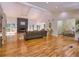 An open-concept living room features hardwood floors, a fireplace, and access to the kitchen and dining room at 2540 Rocky Springs Dr, Marietta, GA 30062