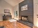 Cozy living room featuring a modern fireplace, hardwood floors, and access to the outdoor patio at 2540 Rocky Springs Dr, Marietta, GA 30062