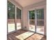 A view of the wood patio with access through glass patio doors and a large window for natural lighting at 2540 Rocky Springs Dr, Marietta, GA 30062