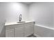 A sink with white shaker cabinets, marble countertop, matte black faucet, and wood-look vinyl flooring at 2540 Rocky Springs Dr, Marietta, GA 30062