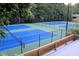 Aerial view of community tennis courts with green and blue playing surfaces and tall fencing at 2540 Rocky Springs Dr, Marietta, GA 30062