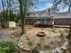 Private backyard with a fire pit, a shed, and mature trees, perfect for outdoor entertaining and relaxation at 4023 Oak Crest Dr, Tucker, GA 30084