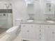 Clean and stylish bathroom with double sink vanity, framed mirrors and a glass enclosed shower at 4023 Oak Crest Dr, Tucker, GA 30084