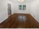 Charming dining room with wood floors, white trim, large windows, and modern chandelier at 4023 Oak Crest Dr, Tucker, GA 30084