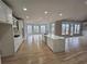 Open kitchen with quartz countertops, stainless steel appliances, white cabinets and a large island at 7910 Tintern Trce, Duluth, GA 30097