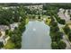 Aerial view of a serene lake within a residential community surrounded by lush trees at 124 Freedom Dr, Acworth, GA 30102