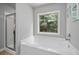 Bright bathroom showcases a large soaking tub next to a seamless glass shower at 124 Freedom Dr, Acworth, GA 30102