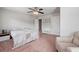 Bedroom showcasing a quilt bedspread, chair, and neutral colored carpet at 124 Freedom Dr, Acworth, GA 30102