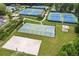 Aerial view of community tennis courts, a basketball court, and a sand volleyball court in a well-maintained neighborhood at 124 Freedom Dr, Acworth, GA 30102