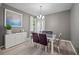 Elegant dining room featuring a modern chandelier and a stylish glass-top dining table at 124 Freedom Dr, Acworth, GA 30102