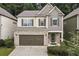 Charming two-story home with brick accents, a two-car garage, and manicured landscaping at 124 Freedom Dr, Acworth, GA 30102
