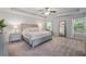 Serene main bedroom with tray ceilings, soft carpet, and abundant natural light at 124 Freedom Dr, Acworth, GA 30102