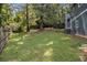A view of the green backyard, fenced in with mature trees at 1621 Northlake Springs Ct, Decatur, GA 30033