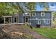 The backyard is grassy and sloped, and the home has blue siding at 1621 Northlake Springs Ct, Decatur, GA 30033