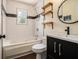 Bathroom featuring a black vanity, a tub, and rustic shelving at 1621 Northlake Springs Ct, Decatur, GA 30033