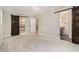 Bright bedroom with barn doors leading to bathroom and closet and light wood floors at 1621 Northlake Springs Ct, Decatur, GA 30033