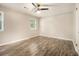 Bedroom featuring a ceiling fan, two windows, and light-colored walls and wood floors at 1621 Northlake Springs Ct, Decatur, GA 30033