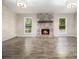 Bright living room with hardwood floors, stone fireplace, and backyard views from the windows at 1621 Northlake Springs Ct, Decatur, GA 30033