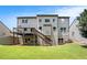 Backyard featuring a two story home, large lawn, and wooden deck with staircase at 1883 Jameson Cir, Lawrenceville, GA 30043