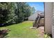 Well-manicured backyard with deck featuring wooden staircase at 1883 Jameson Cir, Lawrenceville, GA 30043
