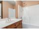 Bathroom features a wood vanity with single sink and a shower with white tile at 1883 Jameson Cir, Lawrenceville, GA 30043