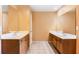 Bathroom with double sinks, mirrors, and wood cabinets, providing a functional space at 1883 Jameson Cir, Lawrenceville, GA 30043
