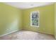 Bright bedroom featuring a window with natural light and neutral carpet at 1883 Jameson Cir, Lawrenceville, GA 30043