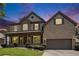 Beautiful two-story brick home with a well-manicured lawn and inviting front porch at dusk at 1883 Jameson Cir, Lawrenceville, GA 30043