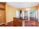 Kitchen with island, granite countertops, wood cabinets, and open access to the living room at 1883 Jameson Cir, Lawrenceville, GA 30043