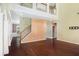 Bright, open-concept living room with hardwood floors, staircase, and a view to the second floor at 1883 Jameson Cir, Lawrenceville, GA 30043