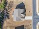 Aerial of a home's roof, driveway, and surrounding yard and street at 3505 Aqua Point Pl, Cumming, GA 30041