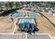 An aerial view shows the community pool, clubhouse, tennis courts, and playground at 3505 Aqua Point Pl, Cumming, GA 30041