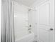 Clean bathroom with a bathtub, shower, and white door at 3505 Aqua Point Pl, Cumming, GA 30041
