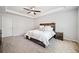 Main bedroom with a tray ceiling, ceiling fan, and rustic decor at 3505 Aqua Point Pl, Cumming, GA 30041