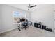 Bright bedroom with a ceiling fan and large window illuminating a desk and office area at 3505 Aqua Point Pl, Cumming, GA 30041