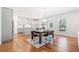Spacious dining area with hardwood floors adjacent to the open kitchen, great for entertaining at 3505 Aqua Point Pl, Cumming, GA 30041