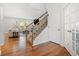Inviting entryway featuring hardwood floors, staircase, and view into living room at 3505 Aqua Point Pl, Cumming, GA 30041