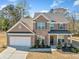 Beautiful two-story brick home with a manicured lawn, covered porch, and a two-car garage at 3505 Aqua Point Pl, Cumming, GA 30041
