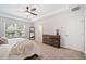 Main bedroom with a tray ceiling, ceiling fan, and rustic wood decor at 3505 Aqua Point Pl, Cumming, GA 30041