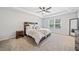 Main bedroom with a tray ceiling, ceiling fan, and rustic decor at 3505 Aqua Point Pl, Cumming, GA 30041