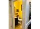 Bright powder room with stylish yellow walls and classic fixtures at 3545 Renaissance Cir, Atlanta, GA 30349
