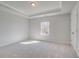 Bright bedroom featuring plush carpet, trim, and a window overlooking the wooded property at 161 Haverling Pass, Hampton, GA 30228